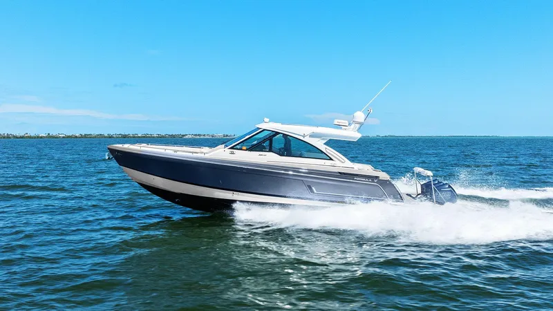  Yacht Photos Pics 2023 Formula 380 Super Sport Crossover OB cruising on open water under clear blue skies.