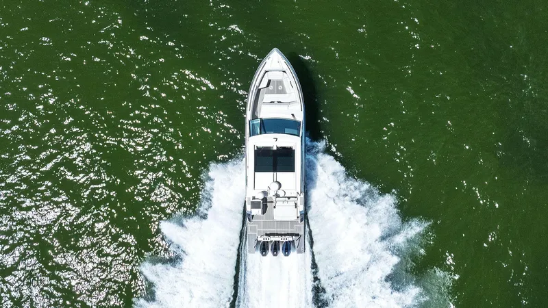  Yacht Photos Pics Aerial view of 2023 Formula 380 Super Sport Crossover OB cruising on green water.
