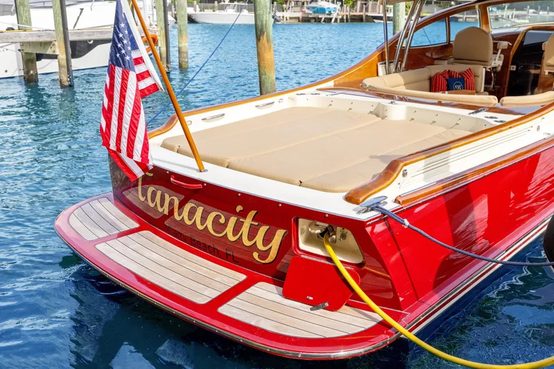 Tanacity Yacht Photos Pics 2009 Hinckley Runabout 38 boat with American flag, docked in marina.