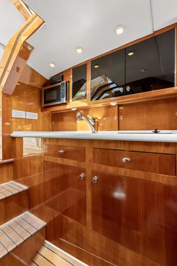 Tanacity Yacht Photos Pics Luxurious 2009 Hinckley Runabout 38 yacht interior with polished wood cabinetry and modern amenities.