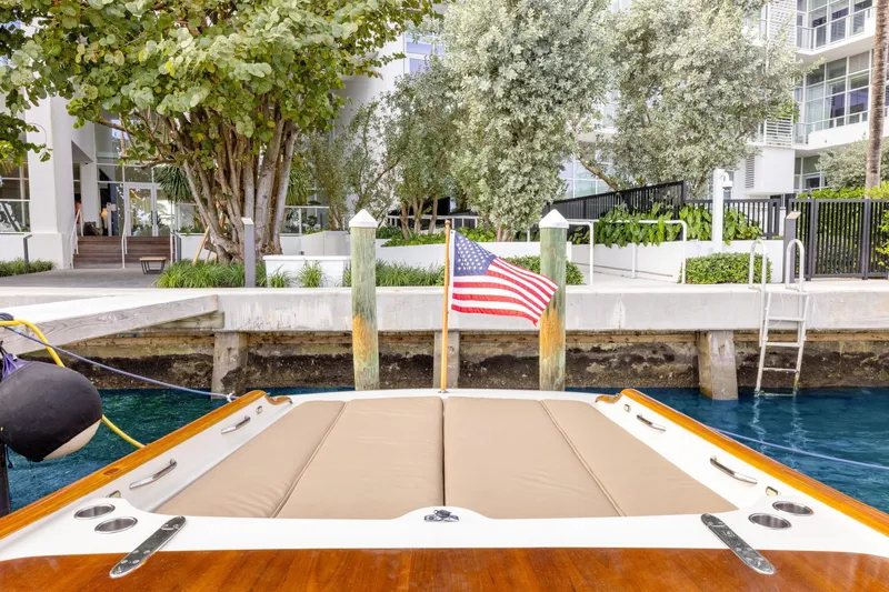 Tanacity Yacht Photos Pics 2009 Hinckley Runabout 38 docked, featuring American flag and waterfront view.