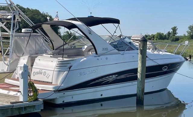 2008 Larson Cabrio 330 Day Cruiser docked at marina, side view.