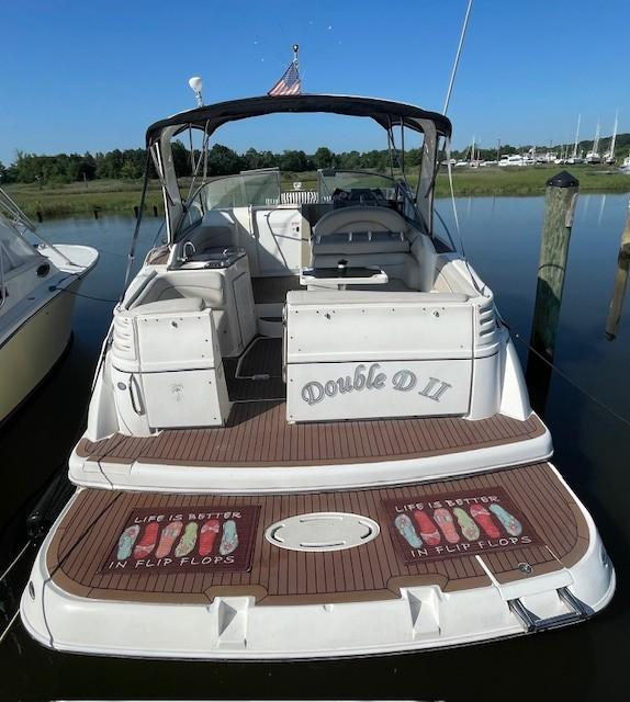 2008 Larson Cabrio 330 Day Cruiser docked, featuring "Double D II" and flip-flop themed deck.