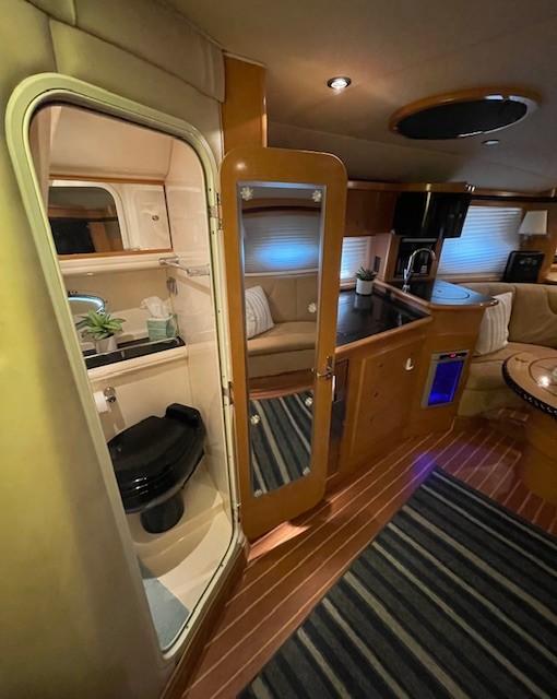 Interior of 2008 Larson Cabrio 330 Day Cruiser with kitchenette and bathroom.