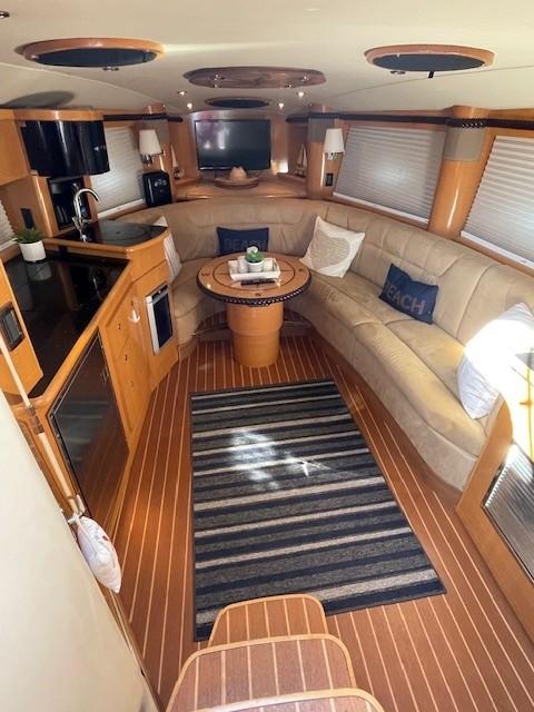 2008 Larson Cabrio 330 Day Cruiser interior with cozy seating and modern kitchen amenities.