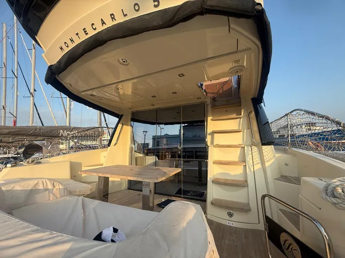  Yacht Photos Pics 2018 Beneteau Monte Carlo 5 yacht interior with seating, table, and stairs.