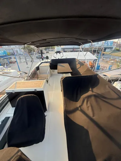  Yacht Photos Pics 2018 Beneteau Monte Carlo 5 yacht deck with covered seating and helm station.