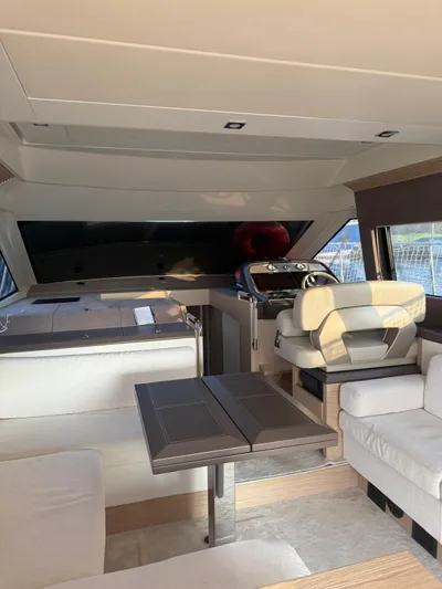  Yacht Photos Pics Interior of 2018 Beneteau Monte Carlo 5 yacht, featuring modern seating and helm station.