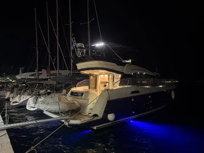  Yacht Photos Pics 2018 Beneteau Monte Carlo 5 yacht docked at night with blue underwater lights.