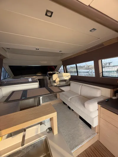  Yacht Photos Pics Luxurious interior of 2018 Beneteau Monte Carlo 5 yacht with modern furnishings and ample seating.