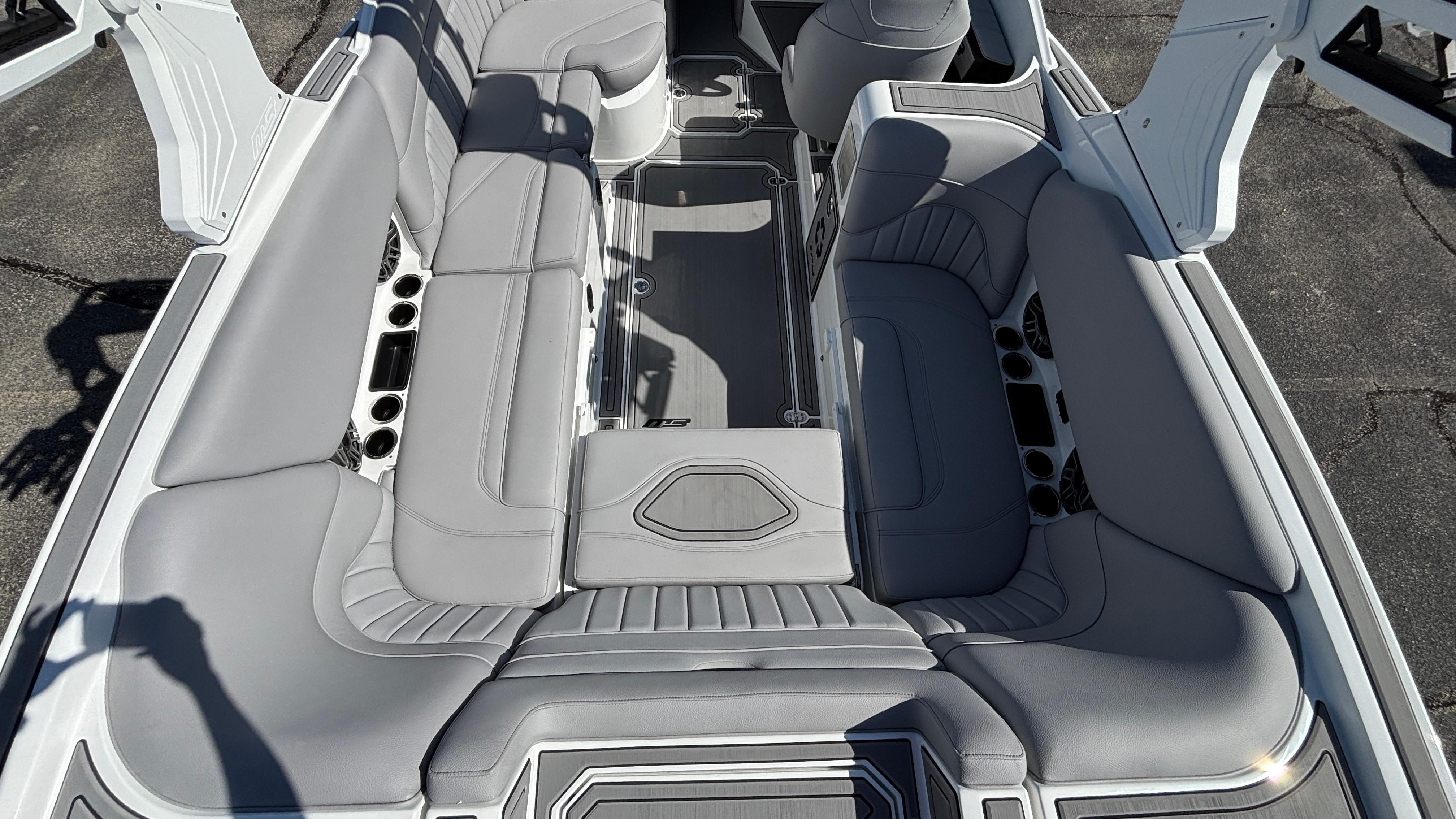 Luxurious interior of 2025 MB B52 25 Alpha boat with gray seating and modern design.
