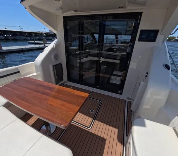  Yacht Photos Pics 2019 Carver C37 Coupe yacht deck with wooden table and glass doors.