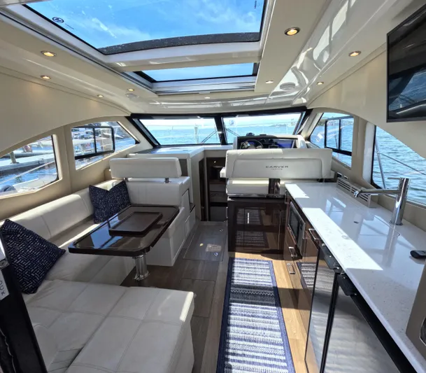  Yacht Photos Pics Luxurious interior of 2019 Carver C37 Coupe yacht with modern furnishings and panoramic windows.