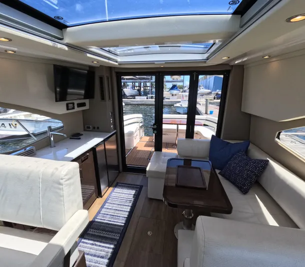  Yacht Photos Pics Interior of 2019 Carver C37 Coupe yacht with modern seating and kitchen area.
