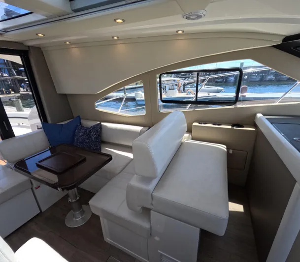 Yacht Photos Pics Interior of 2019 Carver C37 Coupe yacht with plush seating and waterfront view.