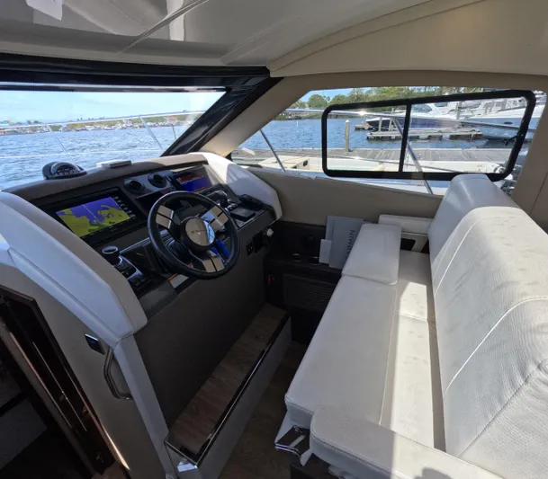  Yacht Photos Pics Interior of 2019 Carver C37 Coupe yacht with steering wheel and navigation screens.
