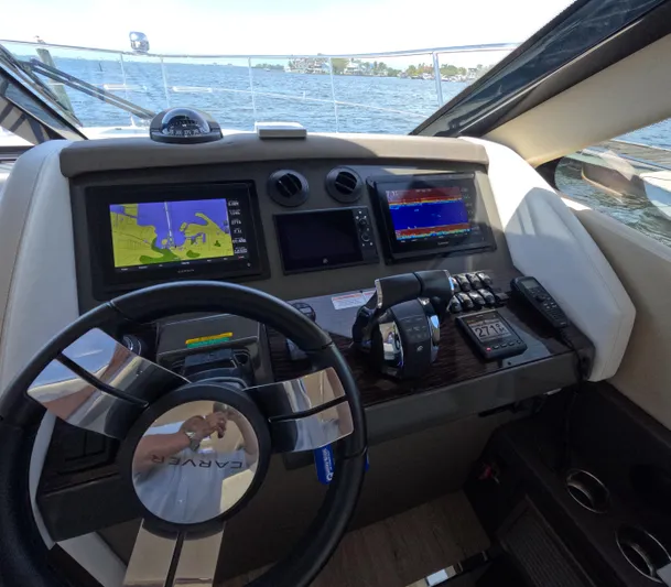  Yacht Photos Pics Helm of 2019 Carver C37 Coupe with navigation screens and controls, overlooking water.