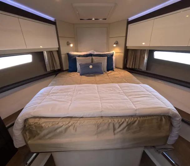  Yacht Photos Pics Luxurious bedroom interior of 2019 Carver C37 Coupe yacht with elegant bedding and ambient lighting.