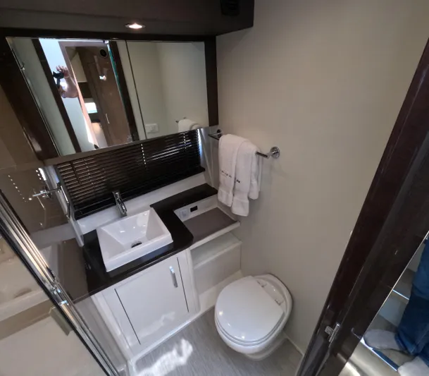  Yacht Photos Pics Luxurious bathroom in 2019 Carver C37 Coupe yacht with modern fixtures and elegant design.