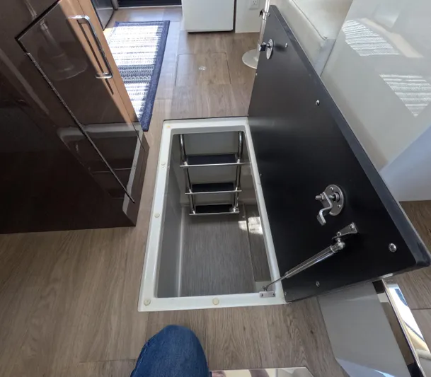  Yacht Photos Pics Open hatch with ladder in 2019 Carver C37 Coupe interior, featuring wood flooring.