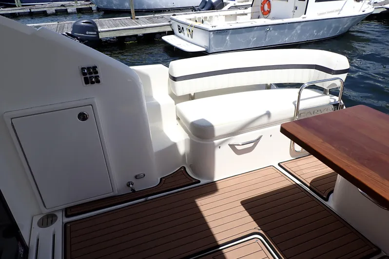  Yacht Photos Pics 2019 Carver C37 Coupe boat interior with seating and wooden deck.
