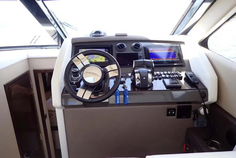  Yacht Photos Pics Helm of 2019 Carver C37 Coupe with modern navigation and control systems.