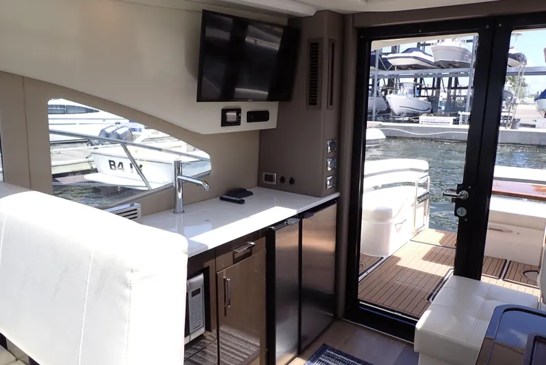  Yacht Photos Pics Interior of 2019 Carver C37 Coupe yacht with kitchenette and water view.