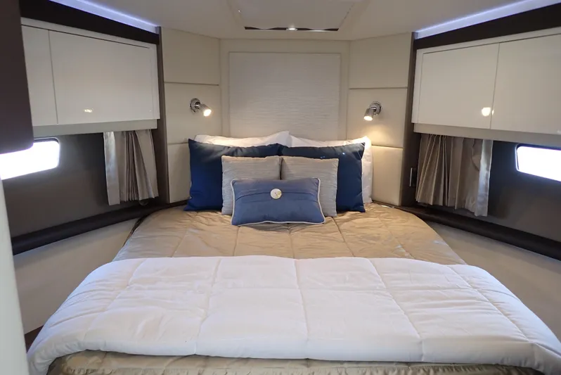  Yacht Photos Pics Luxurious bedroom interior of 2019 Carver C37 Coupe yacht with elegant bedding and lighting.