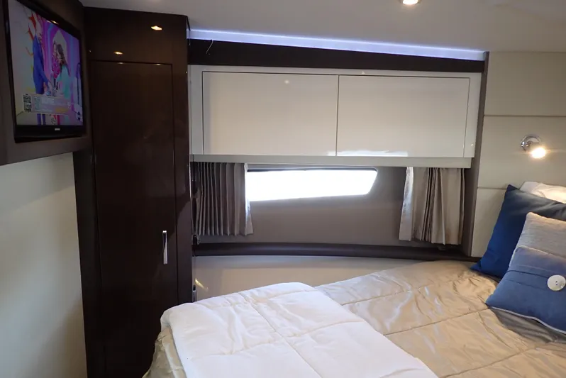  Yacht Photos Pics Luxurious interior of 2019 Carver C37 Coupe with cozy bed and modern TV setup.