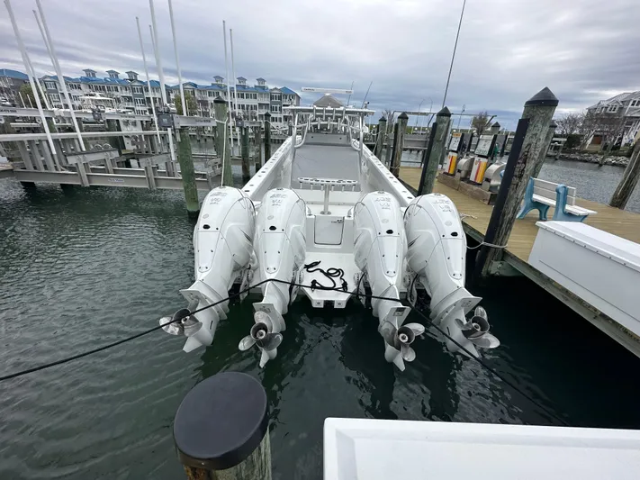 Knot Free Yacht Photos Pics 2021 SeaHunter 46 CTS boat docked with four powerful outboard engines.