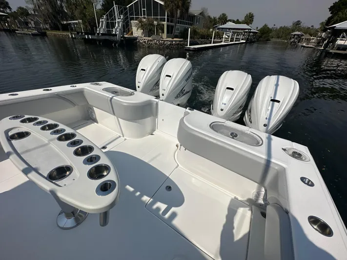Knot Free Yacht Photos Pics 2021 SeaHunter 46 CTS boat with triple Yamaha V8 engines, docked near waterfront homes.