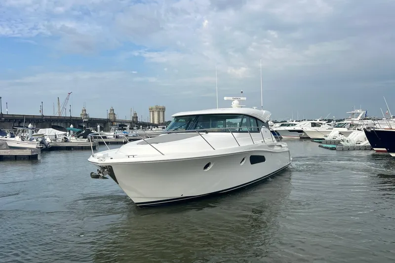 Salty Suite Yacht Photos Pics 2023 Tiara Yachts C44 Coupe in marina, showcasing sleek design and modern features.