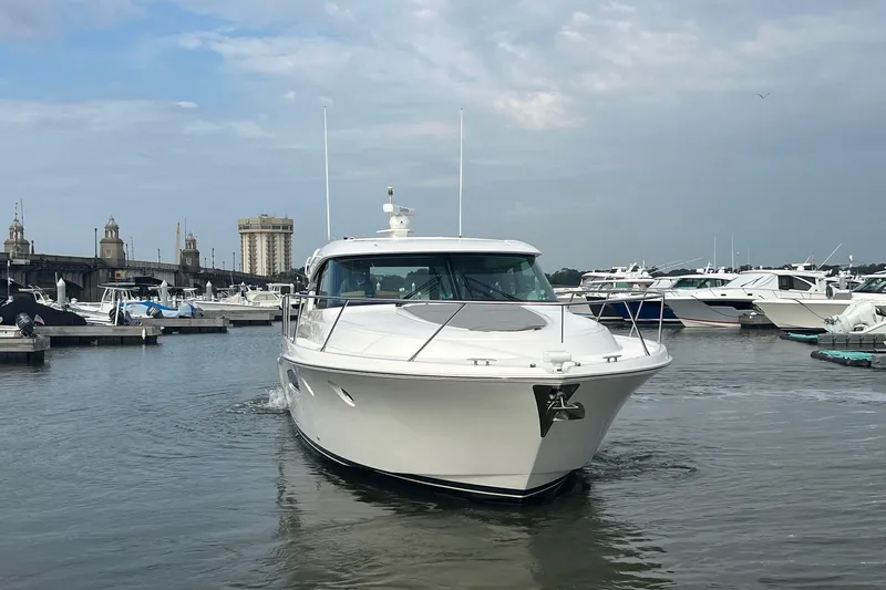 Salty Suite Yacht Photos Pics 2023 Tiara Yachts C44 Coupe in marina, showcasing sleek design and luxury features.