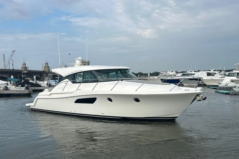 Salty Suite Yacht Photos Pics 2023 Tiara Yachts C44 Coupe in marina, showcasing sleek design and modern features.