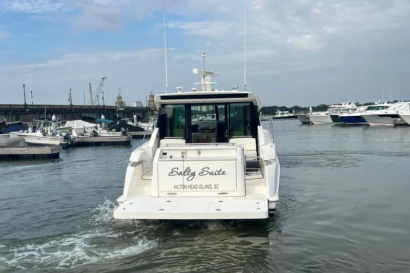 Salty Suite Yacht Photos Pics 2023 Tiara Yachts C44 Coupe in marina, rear view, Hilton Head Island.