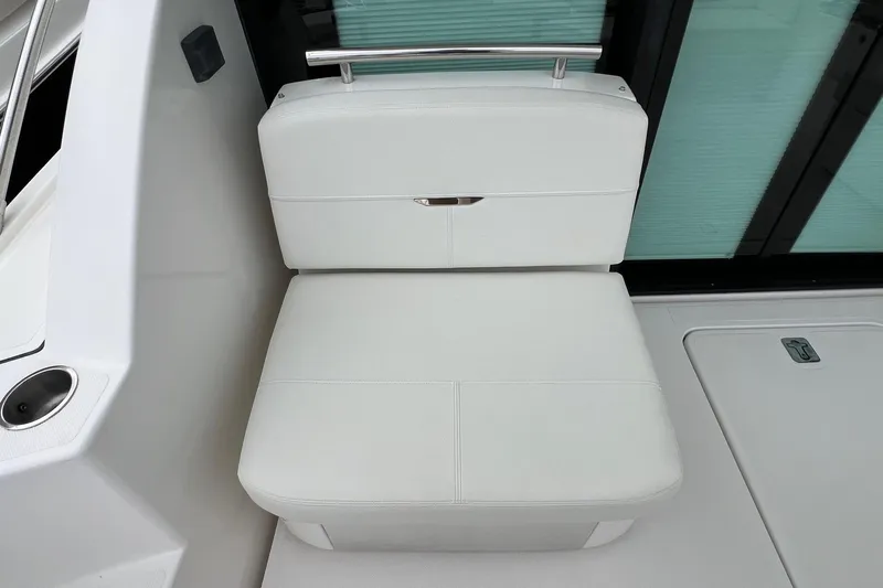 Salty Suite Yacht Photos Pics White seating area on 2023 Tiara Yachts C44 Coupe, featuring sleek design and modern finishes.