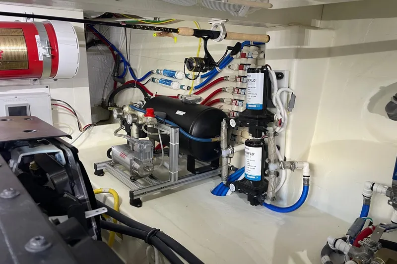 Salty Suite Yacht Photos Pics Engine room of 2023 Tiara Yachts C44 Coupe, showcasing mechanical systems and components.