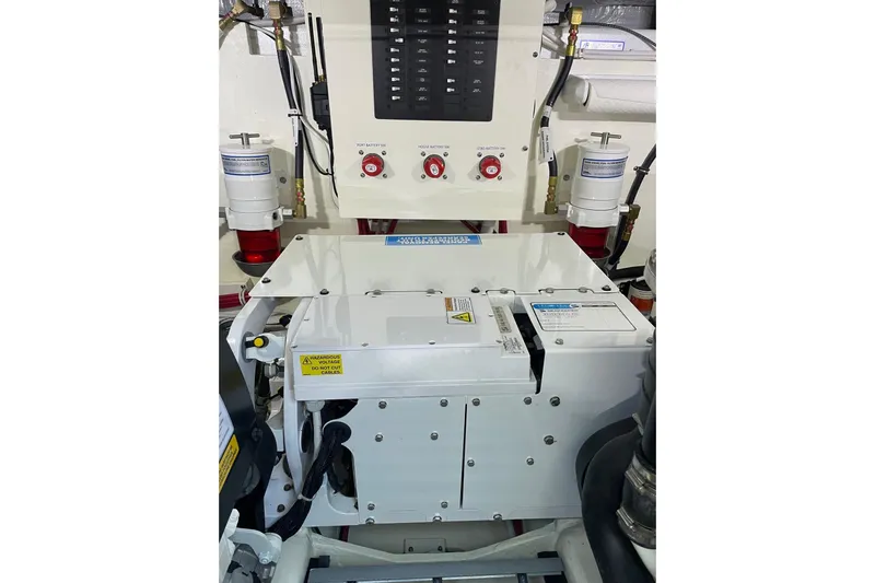 Salty Suite Yacht Photos Pics Engine room of 2023 Tiara Yachts C44 Coupe, featuring control panel and components.