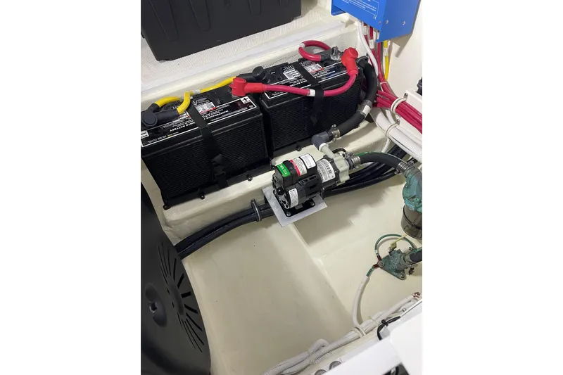Salty Suite Yacht Photos Pics Engine compartment of 2023 Tiara Yachts C44 Coupe, featuring batteries and wiring.
