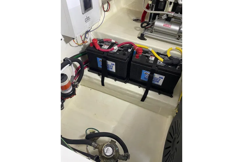 Salty Suite Yacht Photos Pics Engine room of 2023 Tiara Yachts C44 Coupe with batteries and wiring.