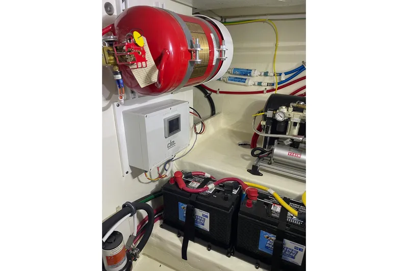 Salty Suite Yacht Photos Pics Engine room of 2023 Tiara Yachts C44 Coupe with fire extinguisher and battery setup.