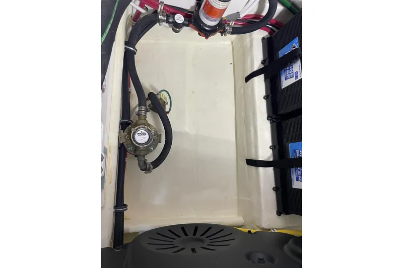 Salty Suite Yacht Photos Pics Engine compartment of 2023 Tiara Yachts C44 Coupe, showcasing mechanical components and wiring.