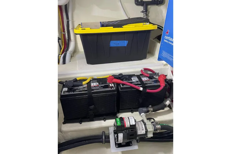 Salty Suite Yacht Photos Pics Electrical system of 2023 Tiara Yachts C44 Coupe, featuring batteries and wiring components.