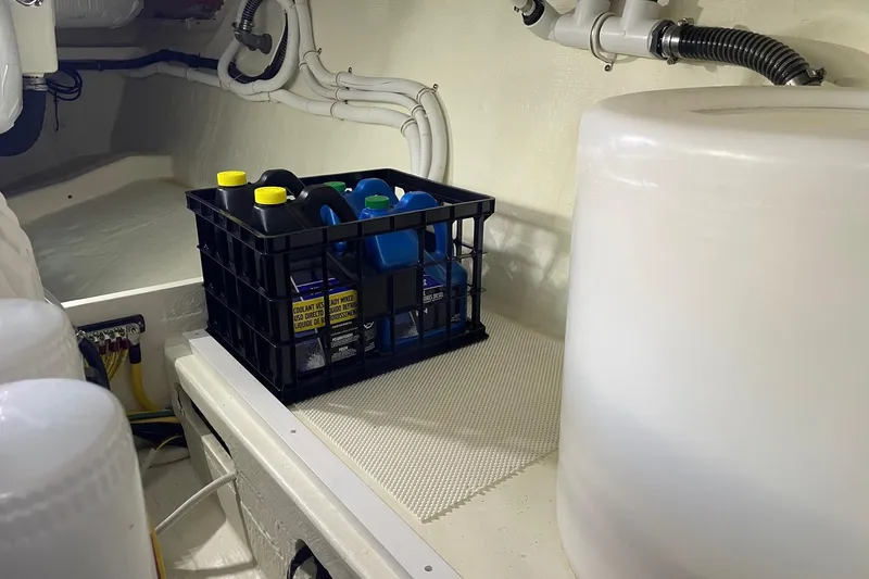 Salty Suite Yacht Photos Pics Engine room of 2023 Tiara Yachts C44 Coupe with storage crate and pipes.