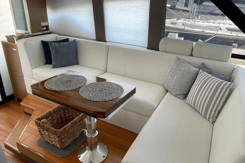 Salty Suite Yacht Photos Pics Luxurious interior of 2023 Tiara Yachts C44 Coupe with elegant seating and stylish decor.