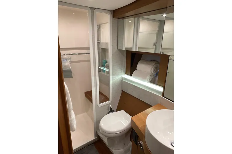 Salty Suite Yacht Photos Pics Luxurious bathroom in 2023 Tiara Yachts C44 Coupe, featuring modern fixtures and elegant design.
