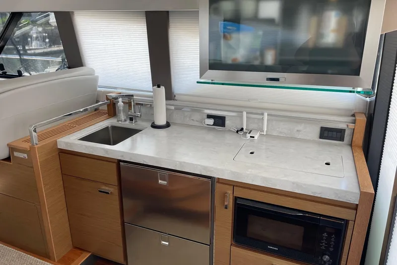Salty Suite Yacht Photos Pics Modern kitchen area in 2023 Tiara Yachts C44 Coupe with sleek appliances.