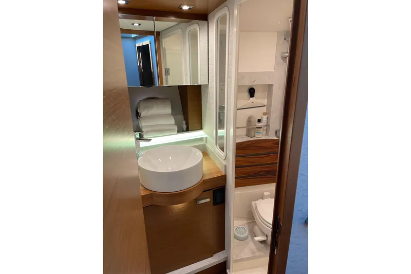 Salty Suite Yacht Photos Pics Luxurious bathroom in 2023 Tiara Yachts C44 Coupe, featuring modern fixtures and elegant design.