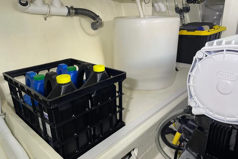 Salty Suite Yacht Photos Pics Engine room of 2023 Tiara Yachts C44 Coupe with storage containers and equipment.