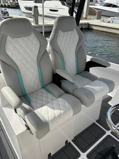 Hull 106 Yacht Photos Pics Luxury seating on 2025 Hammer Yachts HammerCat 30, featuring quilted upholstery and armrests.